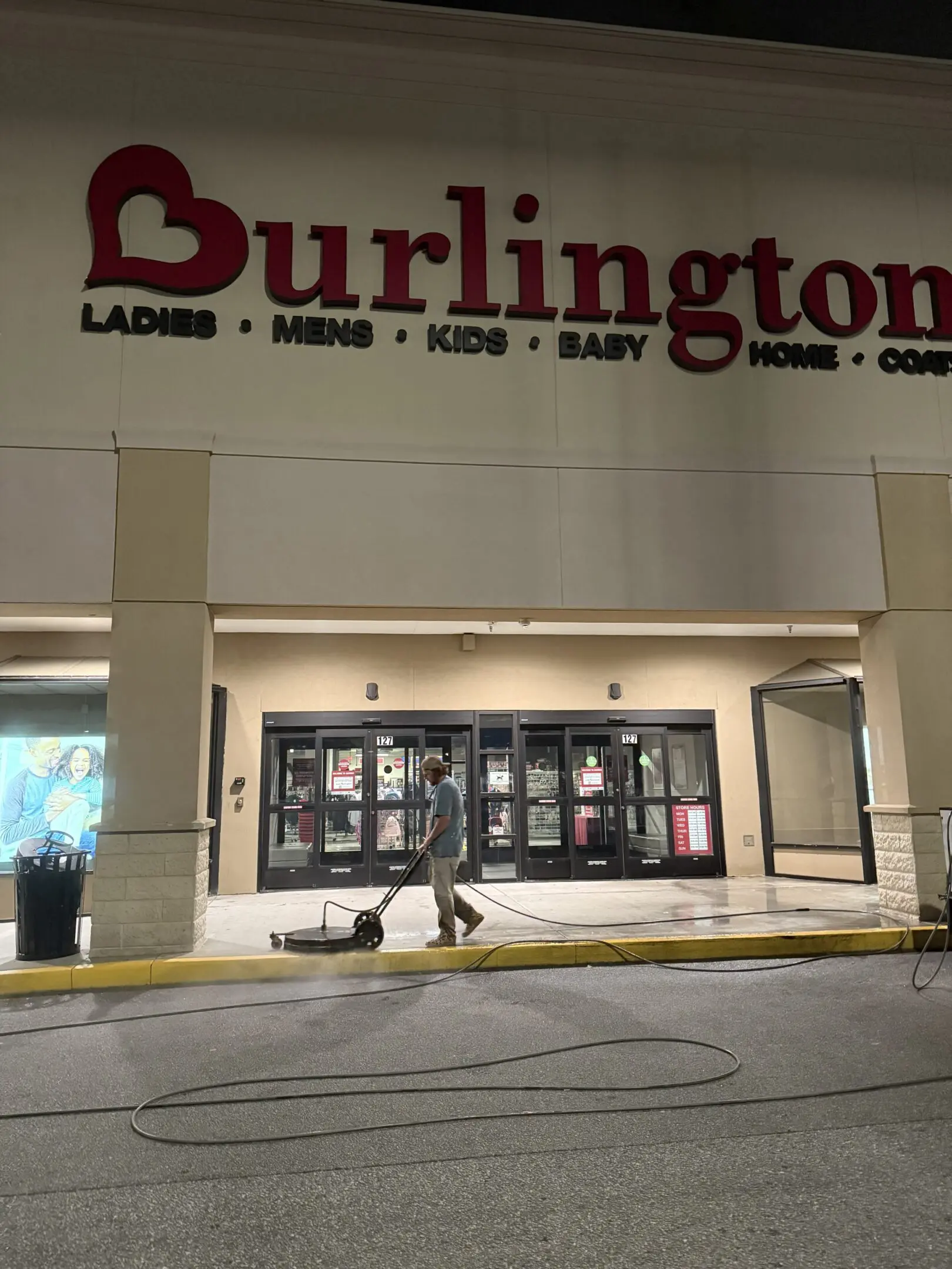 Night view of a closed Burlington store with shopping carts outside.
