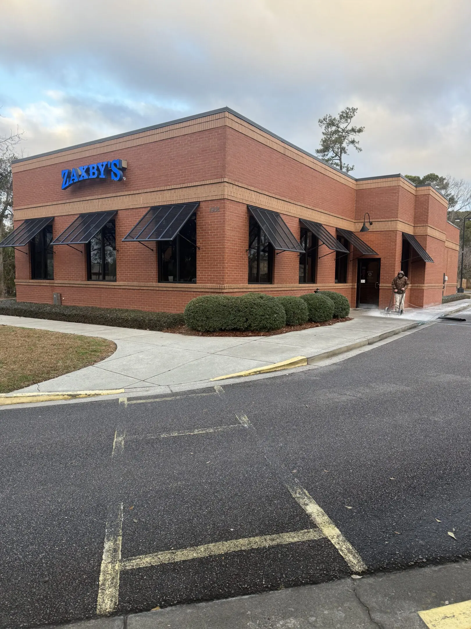 Exterior view of a brick building with a sign labeled 'TANDY'.