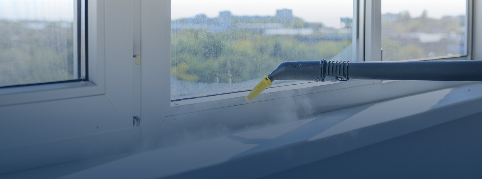 Window being cleaned with steam cleaner.